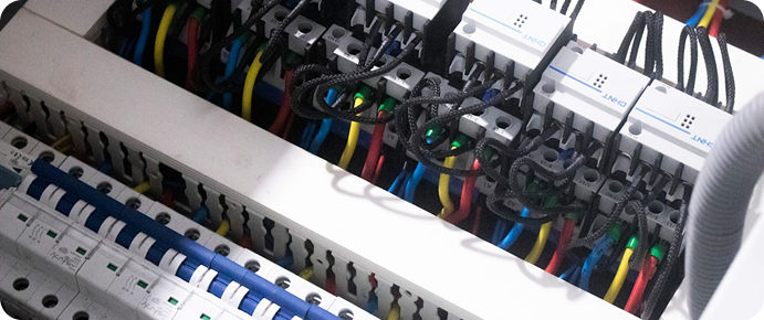Electrical control panel with organized wiring and switchgear