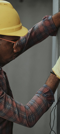 Technician in a hard hat working with focus on site